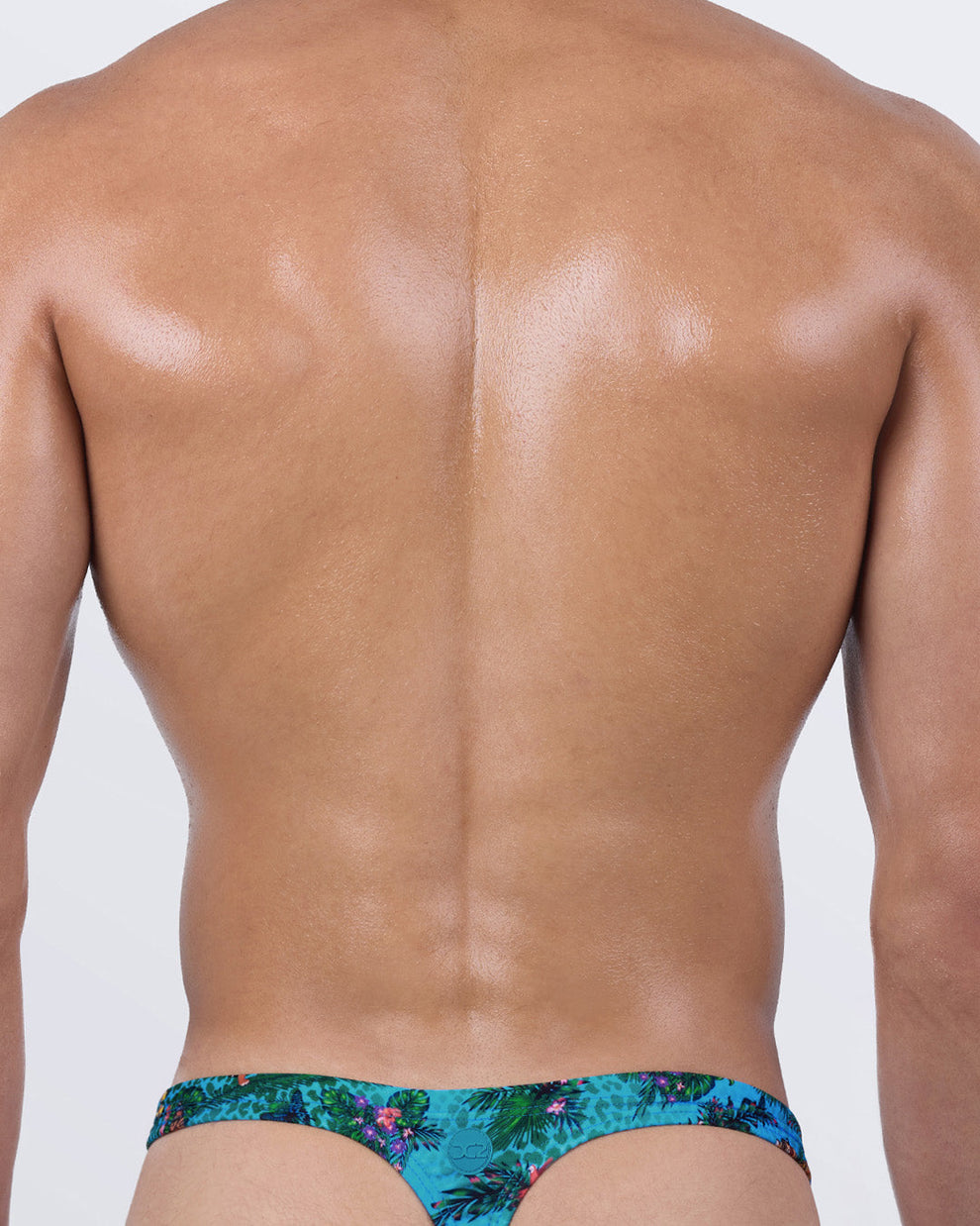 Back view of Jungle Boogie swim thong for men — DC2 Miami men’s thong swimwear with T-back shape in jungle print for sexy tan lines and bold summer vibe.