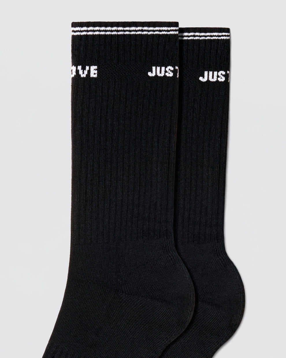 DC2 Justify My Love Ribbed Crew Socks (Black) — close-up of ribbed knit, white cuff stripe, and bold text detail.