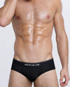 DC2 JUSTIFY MY LOVE Modal Brief — front view of men’s black underwear with bold slogan waistband and snug fit.