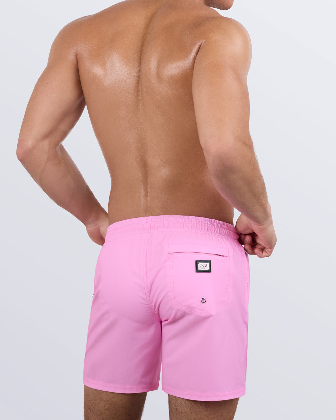 Back view of the LA BEACH EN ROSE beach Resort Shorts in a solid pink color, complete with a back pocket, designed by DC2 a capsule brand by BANG! Clothes based in Miami.