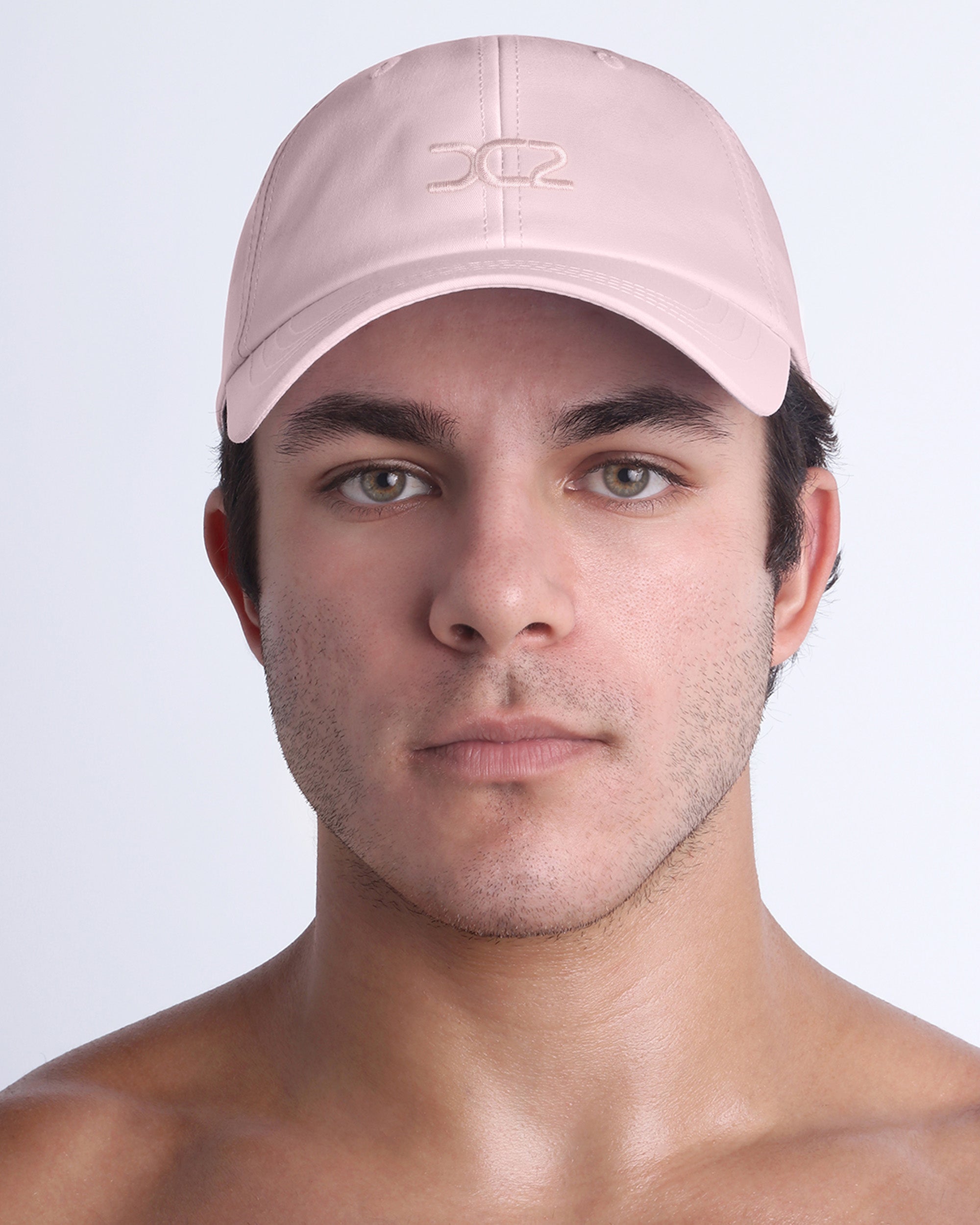 DC2 Resort Cap in Leisure Pink — front view showcasing a curved brim, structured crown, and tonal embroidered DC2 logo.