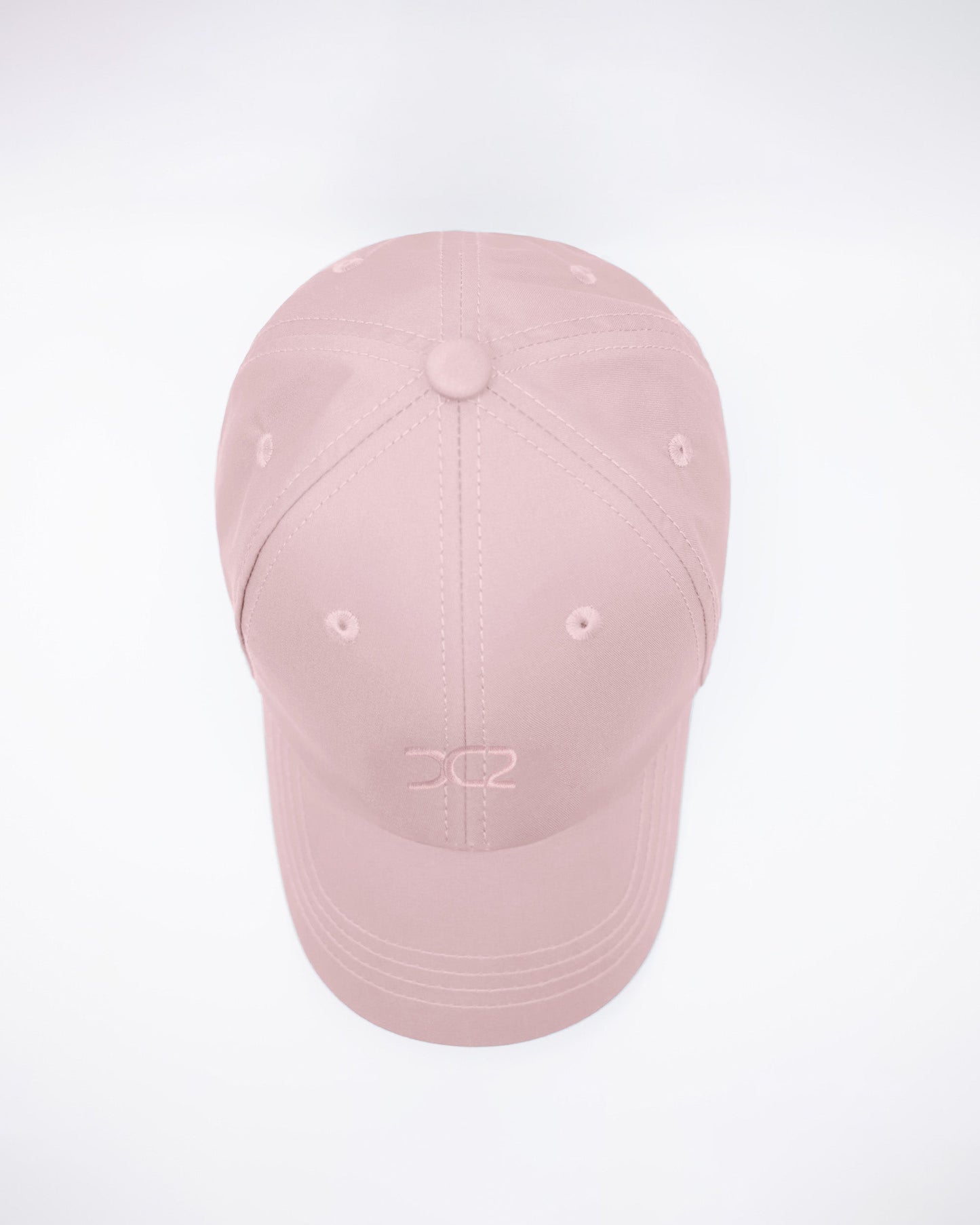 DC2 Leisure Pink Resort Cap — top view highlighting the six-panel construction, stitched seams, and breathable eyelets.