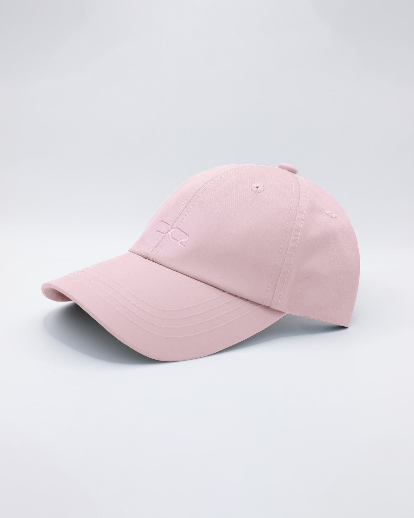 DC2 Leisure Pink Resort Cap — angled view emphasizing the curved brim, clean stitching, and subtle DC2 embroidery.
