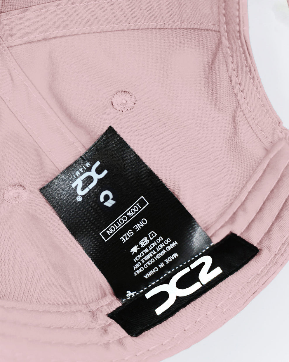 Interior view of the DC2 Leisure Pink Resort Cap — showing soft cotton lining, branded label, and adjustable construction.