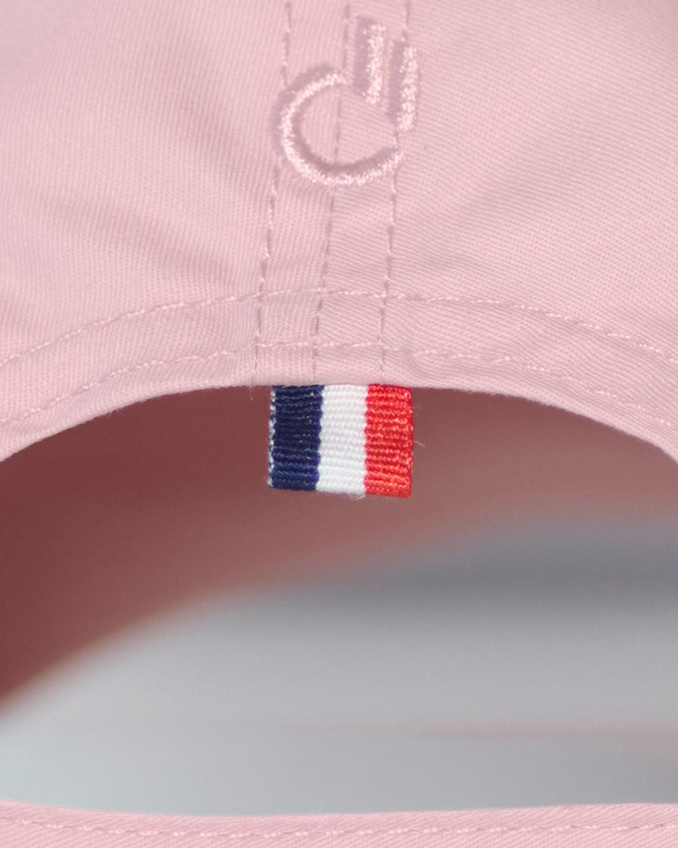 Back detail of the DC2 Resort Cap in Leisure Pink — featuring tonal stitching and a woven tricolor accent tab.