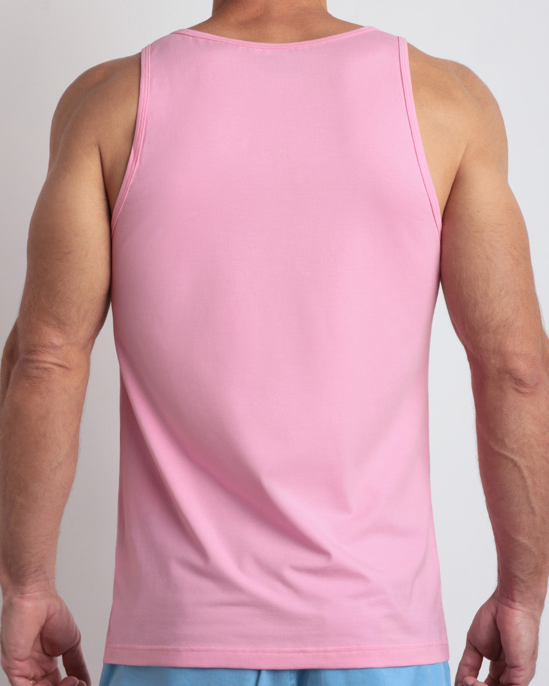 Back view of the LITERALLY PINK men's fitness breathable tank top made of modal cotton blend in a solid bubblegum pink color by DC2 Miami menswear.