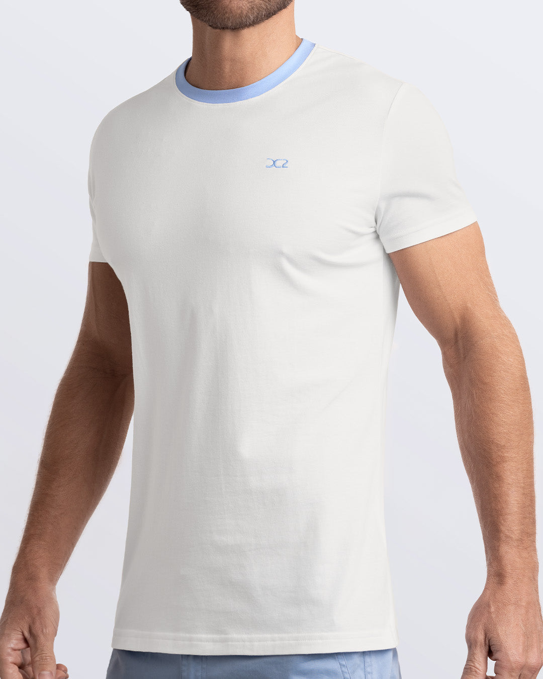 Side view of a men's premium solid white Pima cotton t-shirt with a light blue blue collar and embroidered DC2 logo. Perfect for a modern casual look, this streetwear tee is part of the DC2 Miami men's beachwear collection, designed for comfort and style.