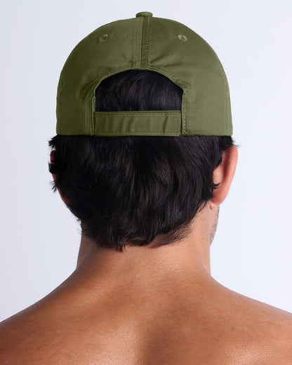 The MAGNUM GREEN Chillax Cap, modeled here, is in deep green. Its adjustable velcro strap at the back ensures a perfect fit for any head size.