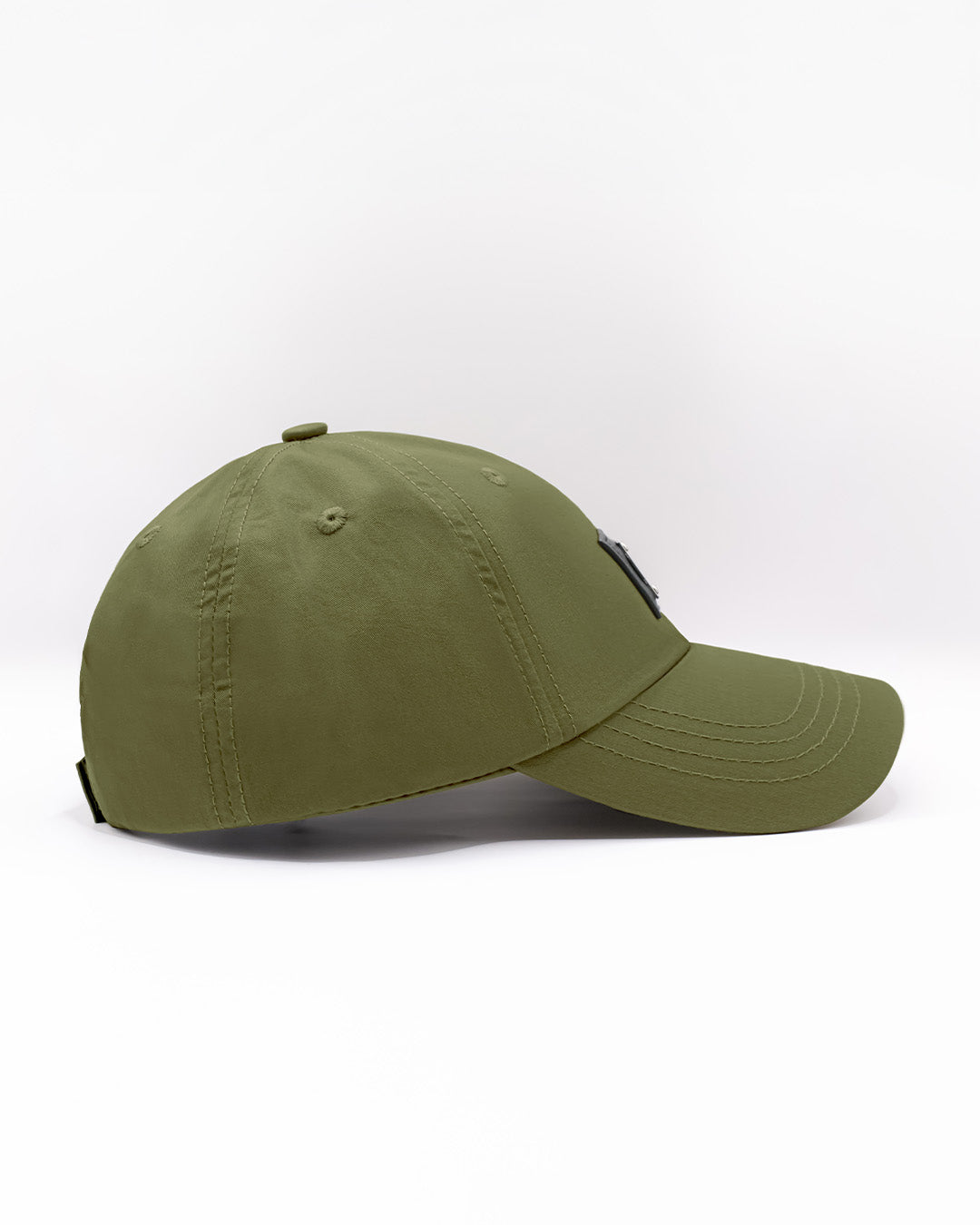 Side view of the MAGNUM GREEN Chillax baseball cap, showcasing its sleek and minimalist design. The cap features a deep olive green color, durable stitching, and a curved brim, perfect for casual and streetwear styles. Made for comfort and style, this dad hat is ideal for everyday wear, whether at the beach or on the streets.