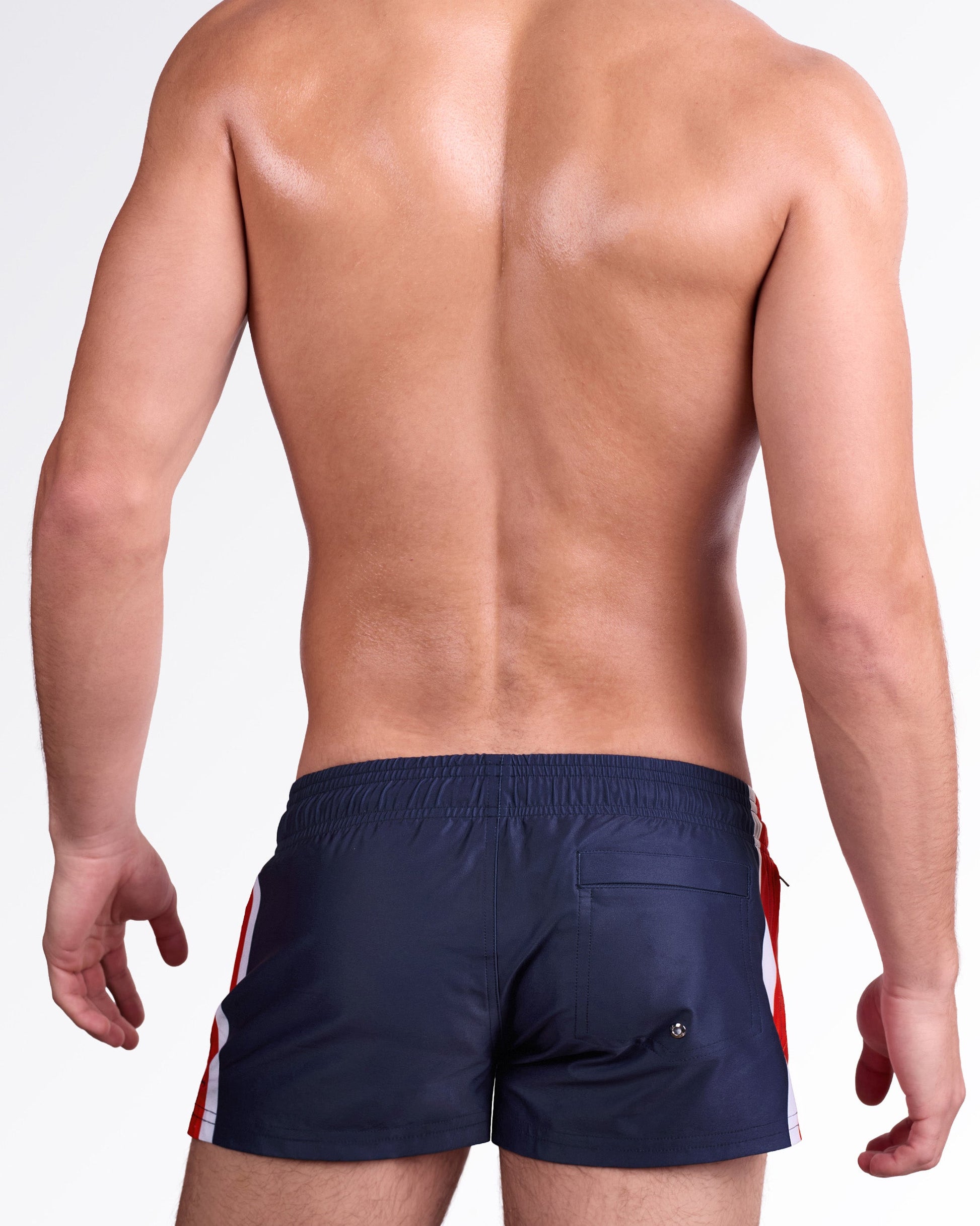 DC2 Maritime Poolside Shorts — model wearing Maritime Poolside Shorts featuring deep navy swim fabric with bold red and white vertical stripe panel and an elastic waistband with adjustable drawstring.