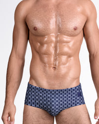 DC2 Mono Waves (Blue) — model wearing Mono Waves Blue Swim Sunga featuring a deep navy base with an all-over geometric wave pattern in crisp white and a sleek, body-contouring silhouette.