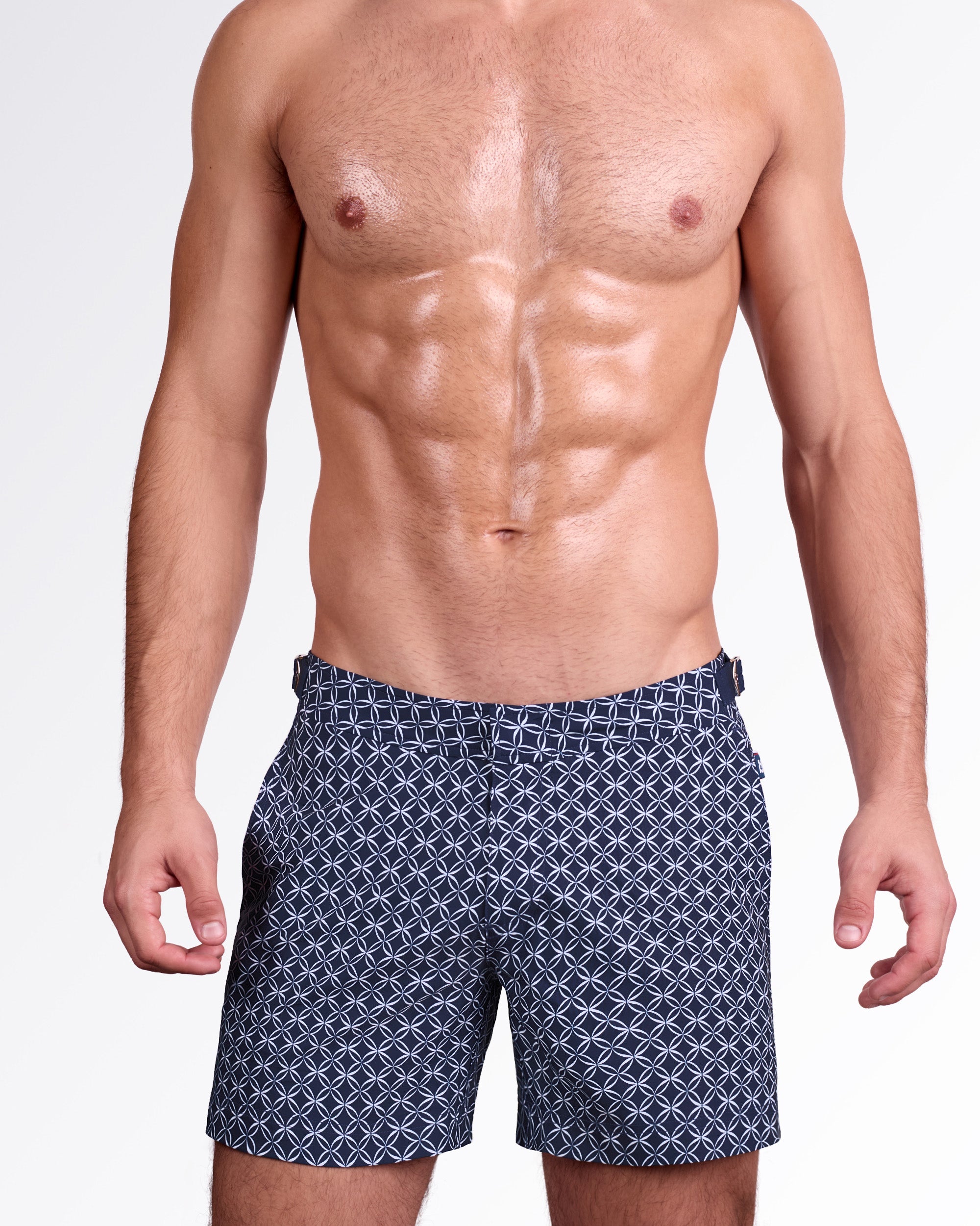 DC2 Miami Mono Waves (Blue) Tailored Shorts — model wearing men’s tailored swim shorts in navy blue with geometric wave pattern, featuring structured waistband with side adjusters and a clean tailored fit.