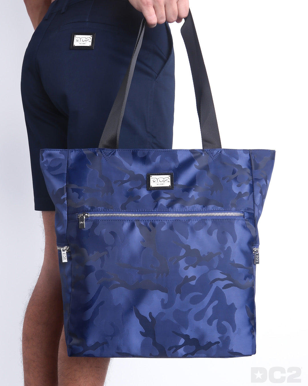 The NAVY BLUE CAMO Poolside Tote Bag in a navy blue camoflauge print. This perfect day tripper bag protect your belongings from spills and splashes designed by DC2 in Miami.