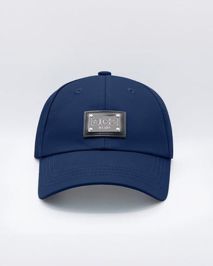 Close-up of a NAVY BLUE Baseball Cap with polished DC2 metallic silver plaque.