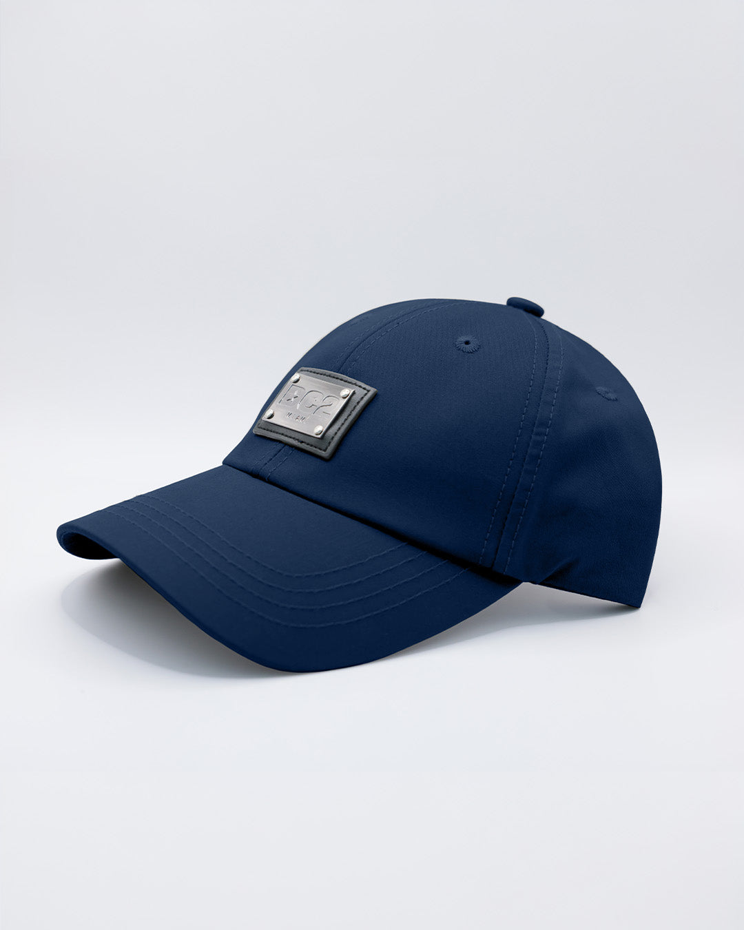 Close-up of a NAVY BLUE Baseball Cap with polished DC2 metallic silver plaque.