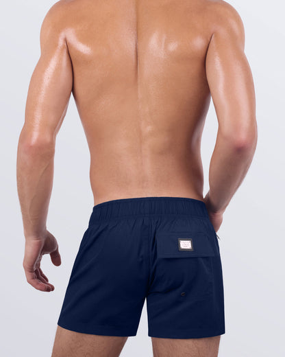 Back view of the NAVY BOOMER - Flex Shorts, showcasing the secure back pocket with a signature logo patch, along with an elasticated waistband for enhanced comfort.