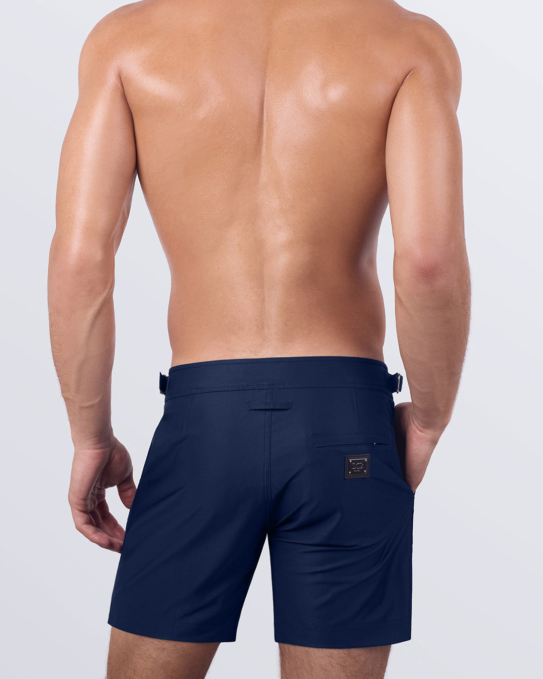 Back view of NAVY BOOMER tailored swim shorts, featuring premium quick-dry fabric, a tailored fit, and a back pocket. Stylish men’s swimwear designed for comfort and sophistication.