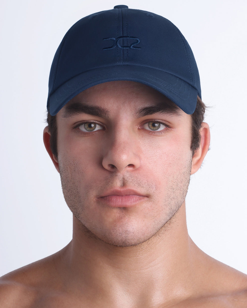 DC2 Resort Cap in navy blue worn by model, minimalist structured baseball cap with tonal embroidered logo.