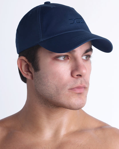 Side profile of DC2 Resort Cap in navy blue, lightweight low-profile baseball cap designed for everyday wear.