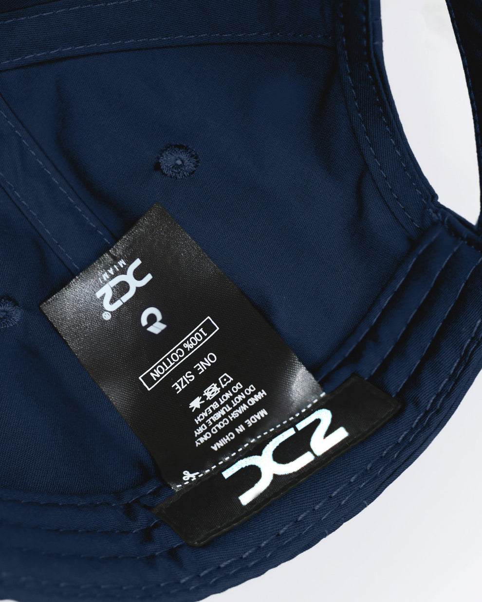 Interior view of the DC2 Navy Blue Resort Cap — showing soft cotton lining, branded label, and adjustable construction.