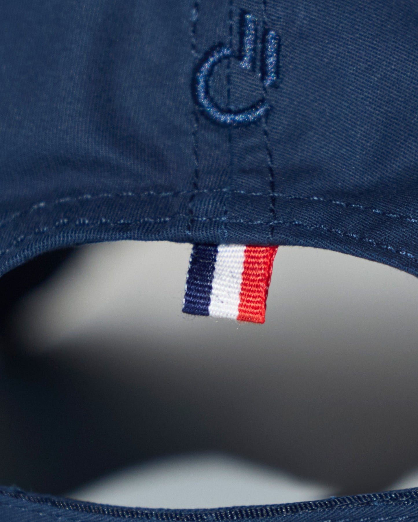 Back detail of the DC2 Resort Cap in Navy Blue — featuring tonal stitching and a woven tricolor accent tab.