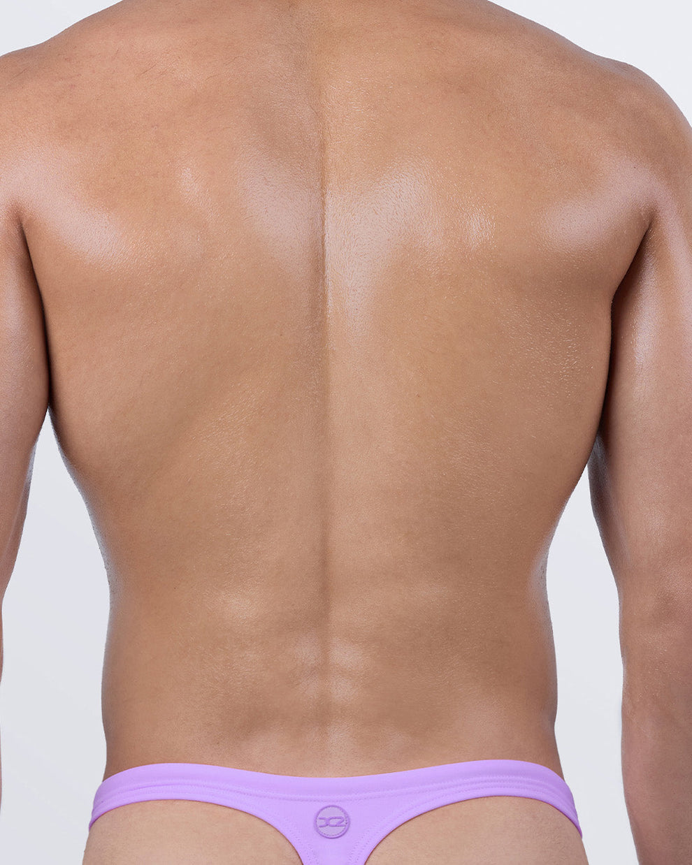 Back view of NEO VIOLET Swim Thong by DC2 – minimal back coverage with “T” shape thong cut, offering perfect tan lines and ultra-sexy beachwear style.
