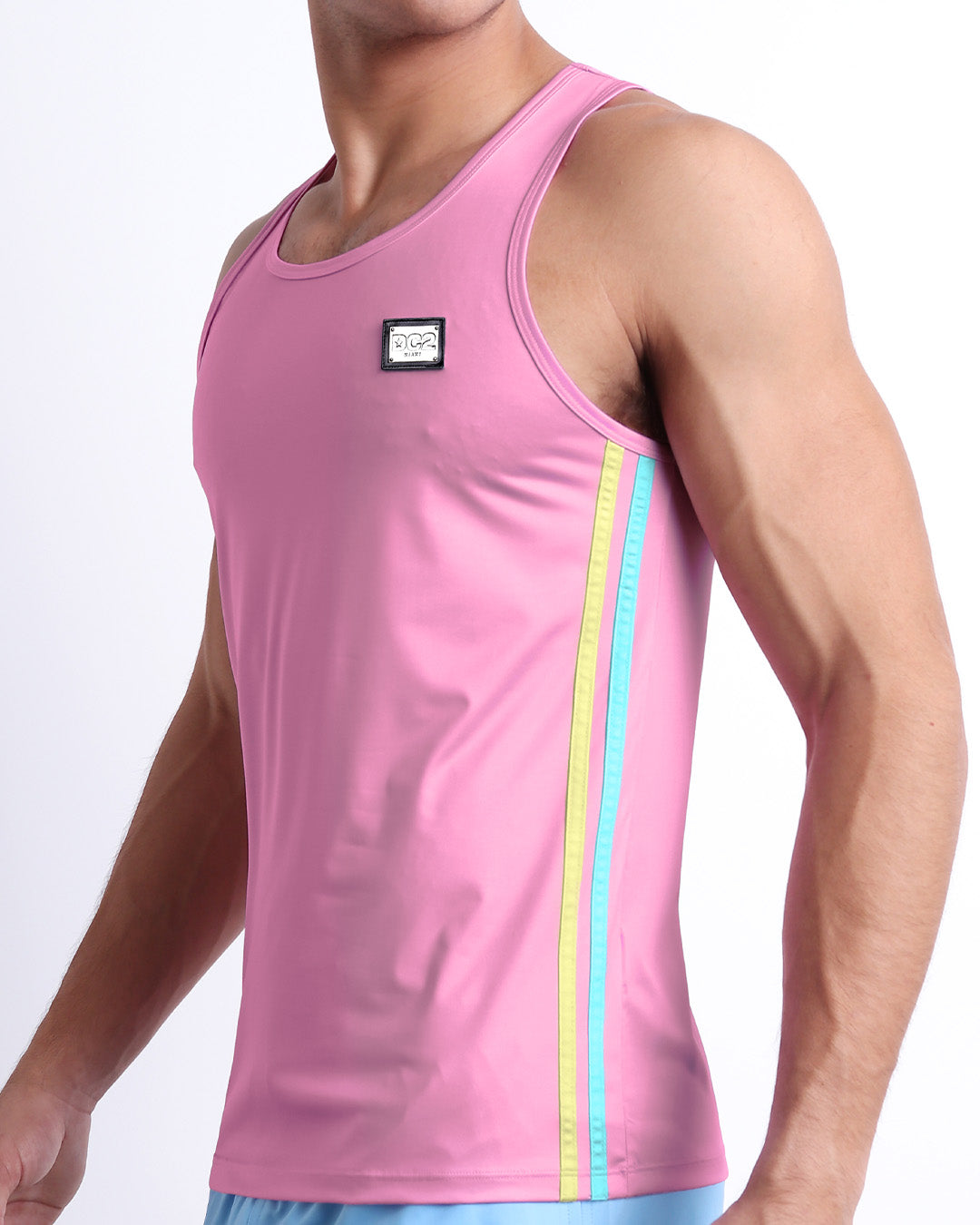 Male model wearing PADAM PINK men’s casual Tank Top. A premium quality top in a solid light pink color with pale yellow and aqua-blue stripes on the sides, a men’s beachwear brand from Miami.