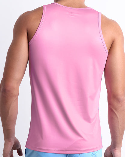 Male model wearing the men's PADAM PINK beach quick-dry tank top for men features a in a solid pink color, made by DC2 a capsule brand by BANG! Clothes in Miami.