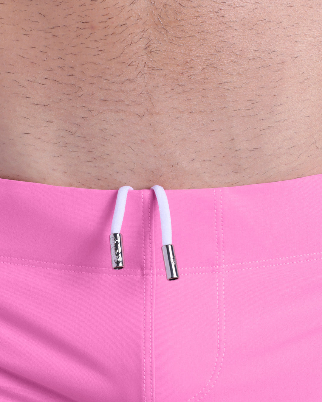 Close-up view of men’s summer beach shorts by DC2 clothing brand, showing white cord with custom branded metallic silver cord ends.