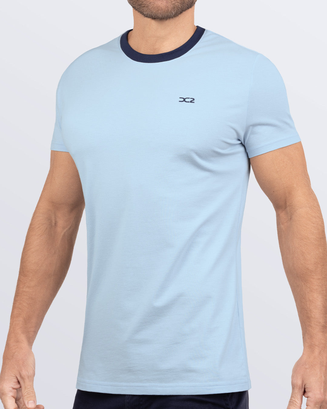 Side view of a men's premium blue Pima cotton t-shirt with a contrasting navy collar and embroidered DC2 logo. Perfect for a modern casual look, this streetwear tee is part of the DC2 Miami men's beachwear collection, designed for comfort and style.