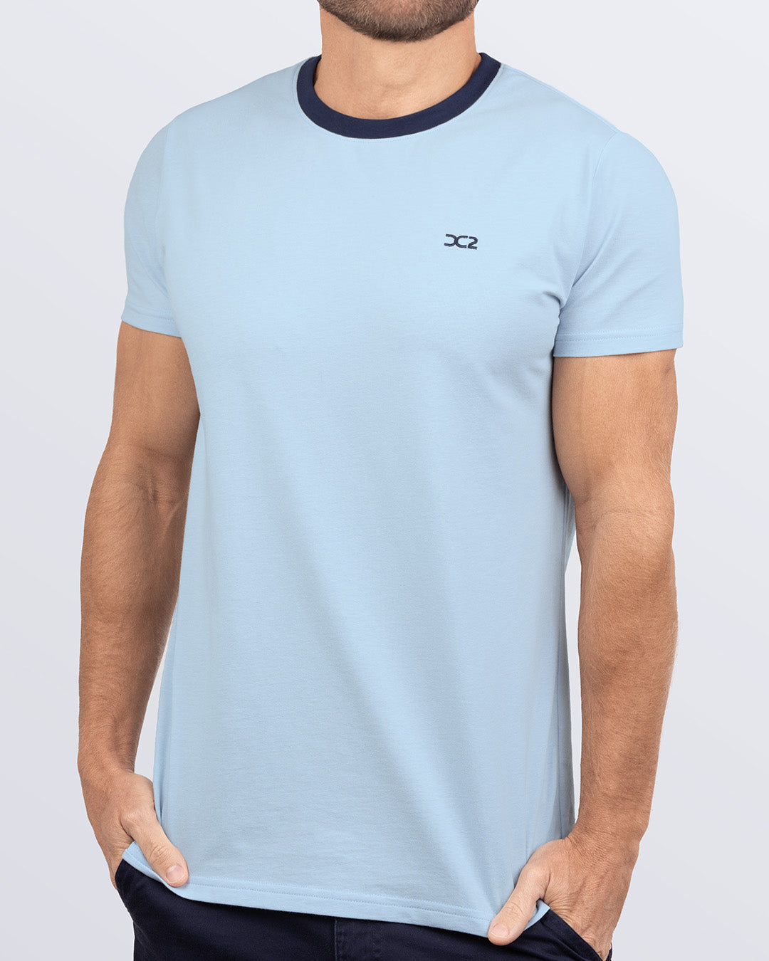 Side view of a men's premium blue Pima cotton t-shirt with a contrasting navy collar and embroidered DC2 logo. Perfect for a modern casual look, this streetwear tee is part of the DC2 Miami men's beachwear collection, designed for comfort and style.