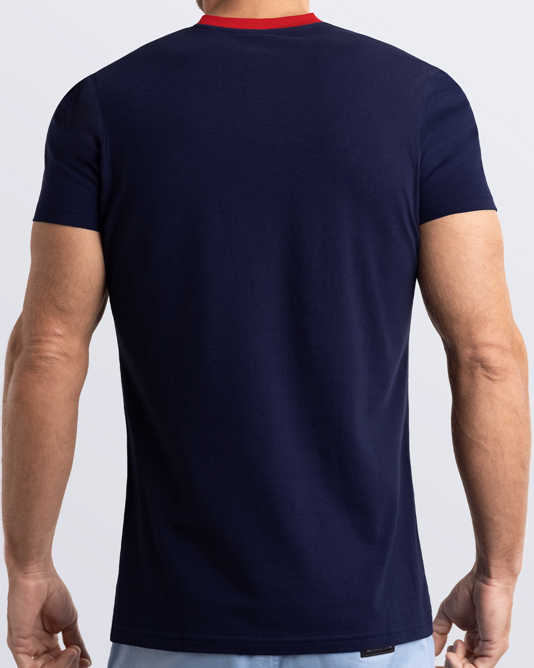 Back view of a navy blue men's t-shirt with a striking red collar, made from soft, durable and breathable Pima cotton. Part of the DC2 Miami men's streetwear and beachwear collection, ideal for casual summer outfits.