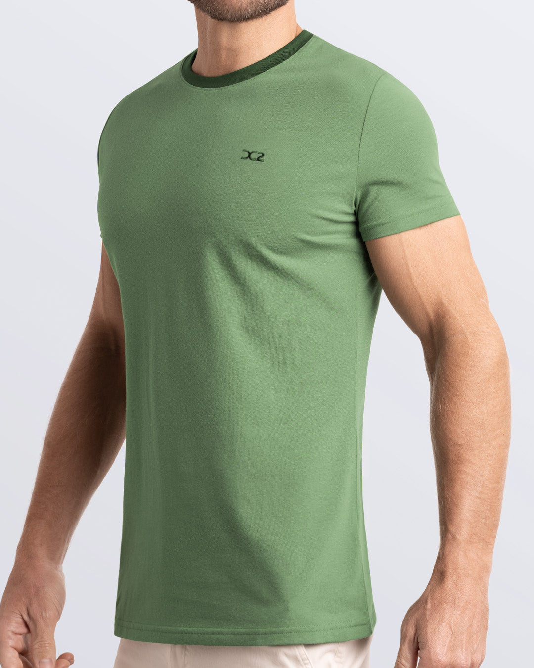 Side view of a men's premium green Pima cotton t-shirt with a contrasting dark green collar and embroidered DC2 logo. Perfect for a modern casual look, this streetwear tee is part of the DC2 Miami men's beachwear collection, designed for comfort and style.