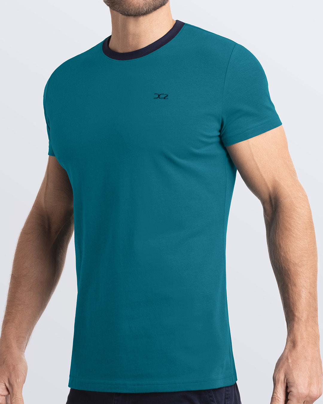 Side view of a men's premium dark aquamarine Pima cotton t-shirt with a contrasting dark navy blue collar and embroidered DC2 logo. Perfect for a modern casual look, this streetwear tee is part of the DC2 Miami men's beachwear collection, designed for comfort and style.