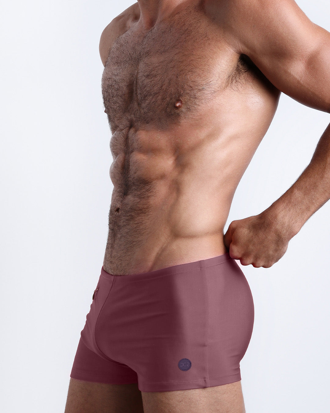 DC2 SANDBAR RED Swim Trunks — side view highlighting the streamlined design and mini zippered pocket detail.