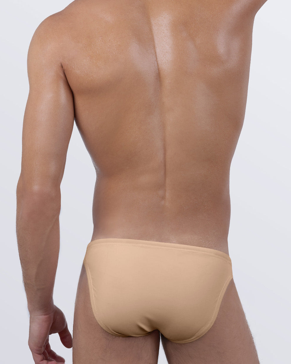 Back view of SKINNY DIP MEDIUM men’s swim mini briefs. Designer men's swimwear with a contouring back cut and smooth finish. Minimalist men’s bathing suit designed for bold summer style.