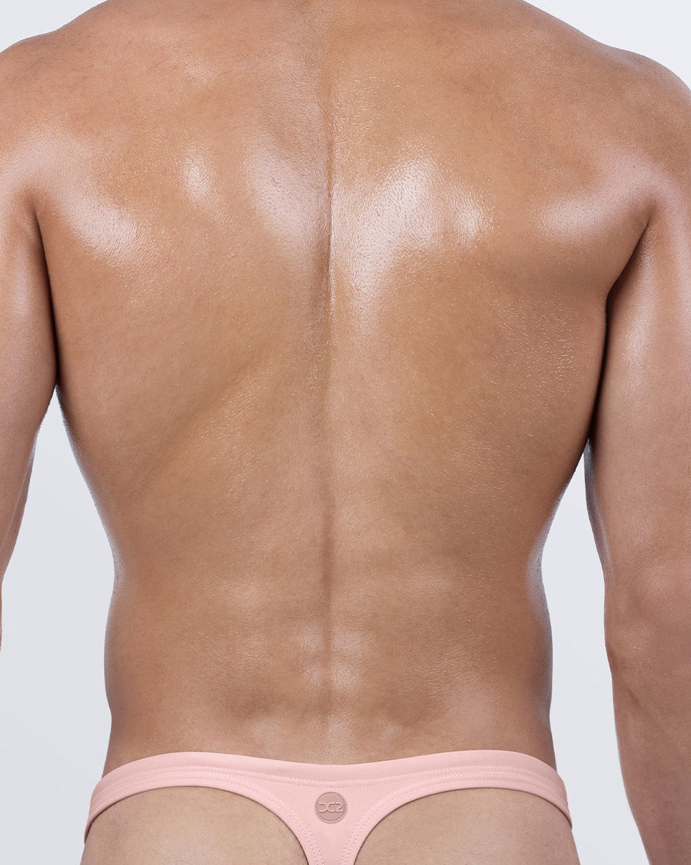Back view of DC2 Skinny Dip thong swimsuit for men – T-back design for enhanced tan lines and minimal coverage.