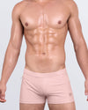 DC2 SKINNY DIP (FAIR) Swim Trunks — model wearing pink square-cut swimsuit with a sculpted skin-hugging fit.