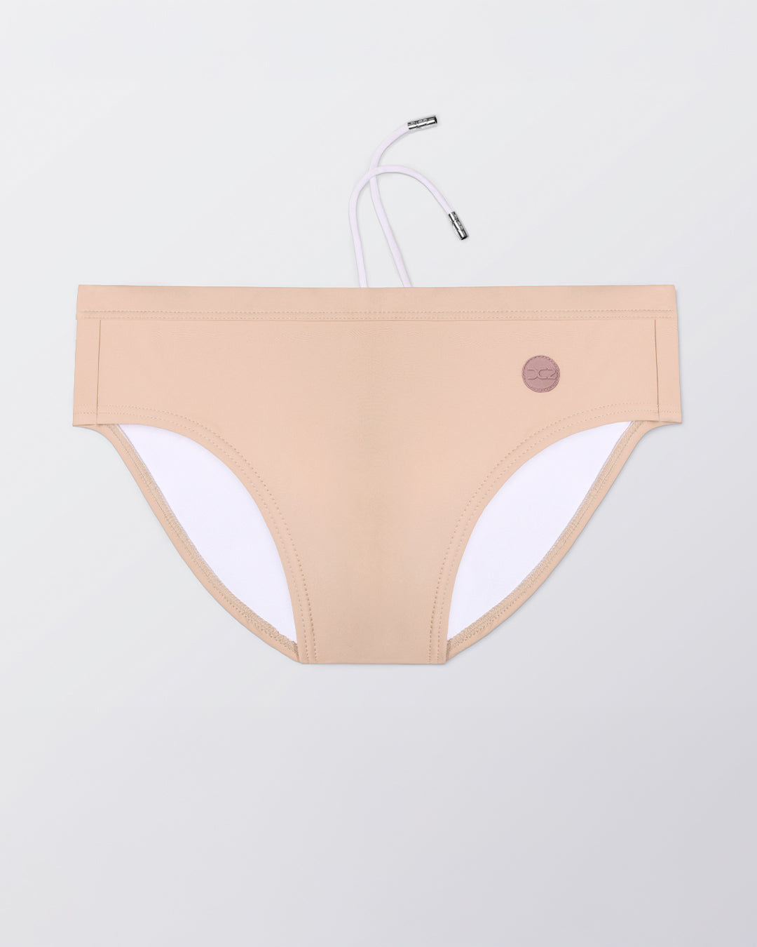 Flat lay of the DC2 Skinny Dip (Light) Swim Brief, featuring a soft neutral tone and sleek, sculpted swim brief design.