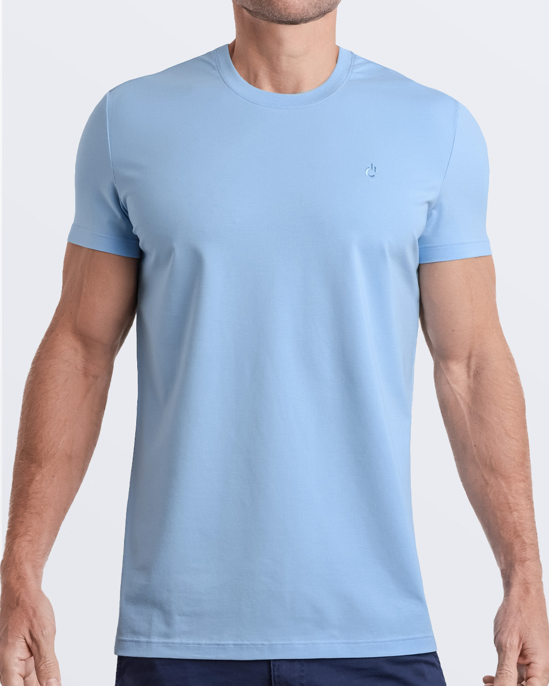 Frontal view of a male model wearing a light blue color modal cotton t-shirt, crafted for stylish casual wear and beachwear by DC2 Miami. Premium quality men's streetwear t-shirt, perfect fit for summer fashion.