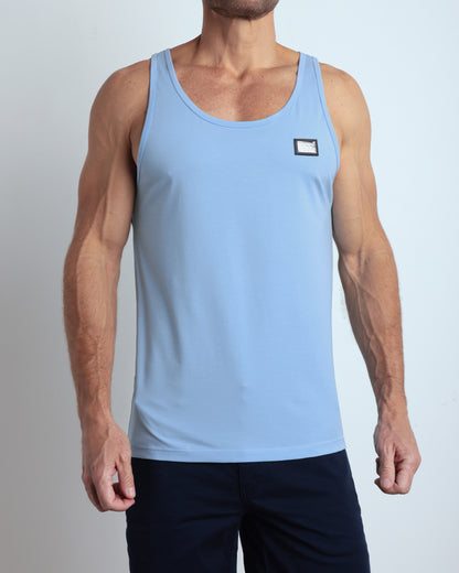 A model wearing the SKY BLUE men's fitness breathable tank top with the BLOOMING BLUE Street Shorts. The casual beach tank top is made of modal cotton blend in a solid light pastel blue color by DC2 Miami menswear.