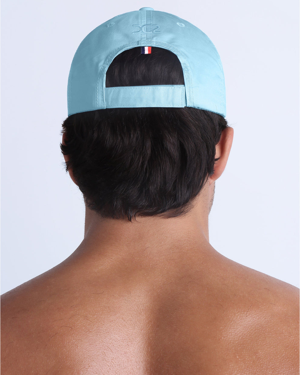 Back view of DC2 sky blue resort cap, adjustable strap closure with a sleek, understated finish.