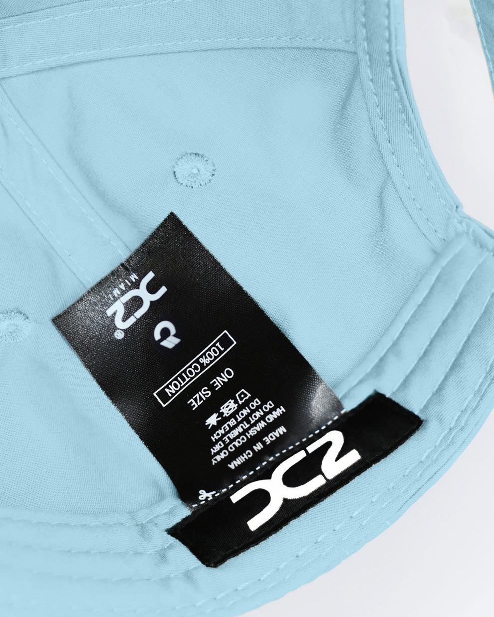 Interior view of the DC2 Sky Blue Resort Cap — showing soft cotton lining, branded label, and adjustable construction.
