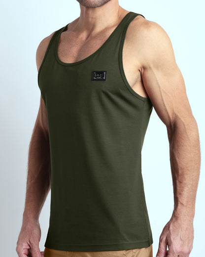 Side view of men’s workout tank top in SLICK GREEN a military green color with a metallic plaque logo made by DC2 Clothing the new official brand of mens beachwear. 