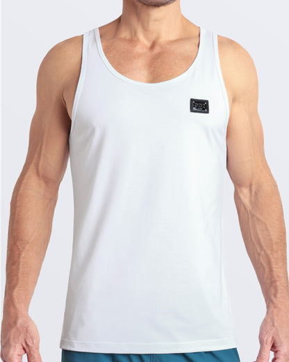 Frontal view of male model wearing the SOFT WHITE in a solid white color casual gym tank top for men by the DC2 brand of men's beachwear from Miami.