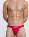 DC2 SOME LIKE IT HOT Modal Thong — front view in red with bold white statement text on soft elastic waistband.