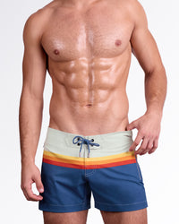 DC2 Miami Sunset Stripes Flex Shorts — model wearing men’s swim shorts in navy blue with multicolor sunset stripe waistband, featuring lace-up front and tailored flex fit.