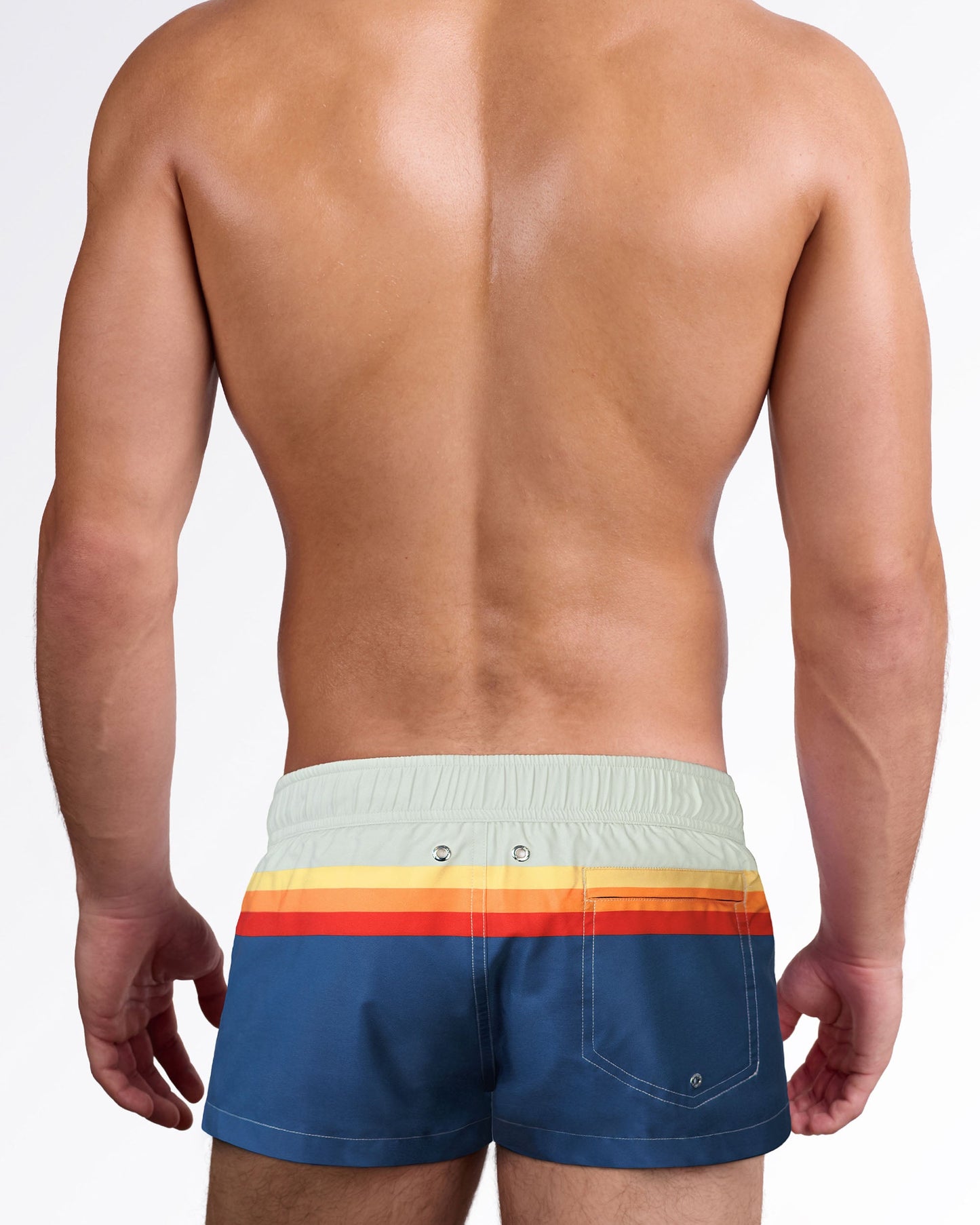 Back view of Sunset Stripes Mini Shorts showcasing the retro stripe design wrapping around the waist, rear pocket, and tailored swim silhouette.