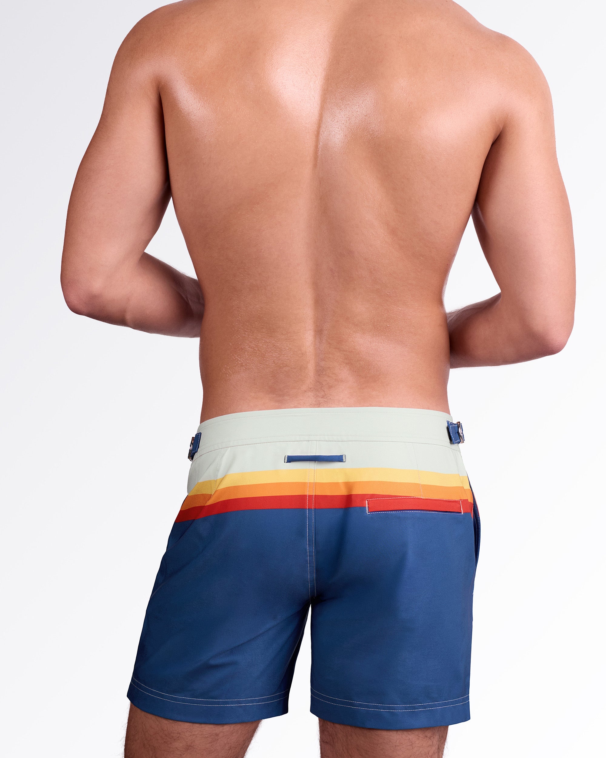 DC2 Miami Sunset Stripes Tailored Shorts — back view highlighting tailored silhouette, rear welt pocket with contrast red detail, and sunset stripe band across the waist.