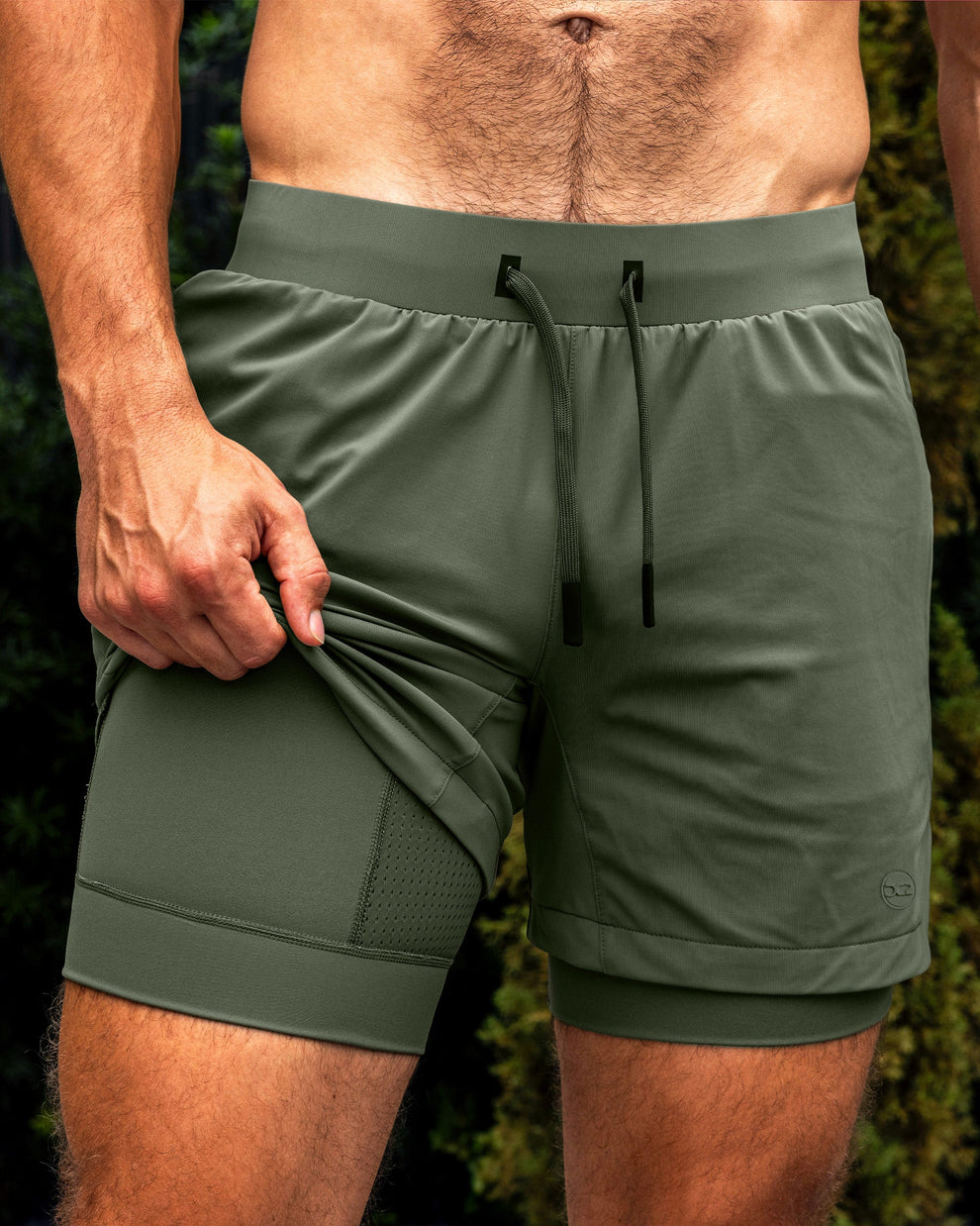 DC2 Tactical Green Endurance Shorts — olive green 2-in-1 performance shorts with built-in compression liner and mesh panel detailing.